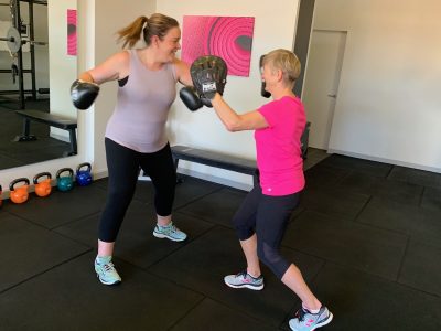 Woman boxing in small group fitness class