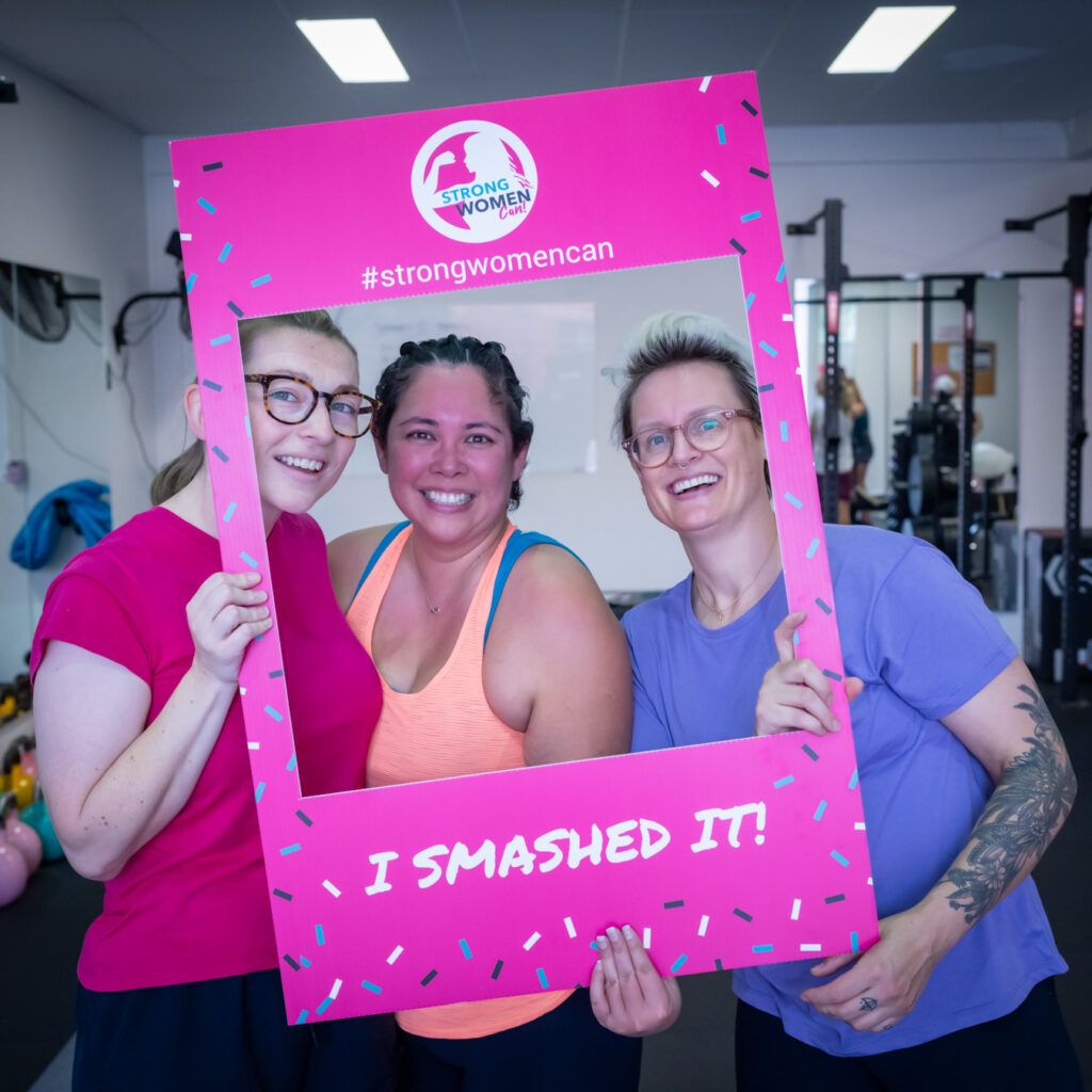 Women celebrating fitness success in small group training class